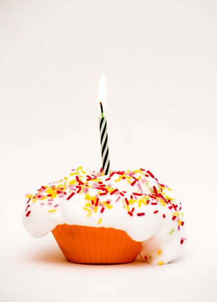 Cupcake with a lit candle - Фото, зображення