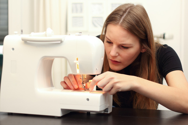 Young woman sewing - Fotó, kép