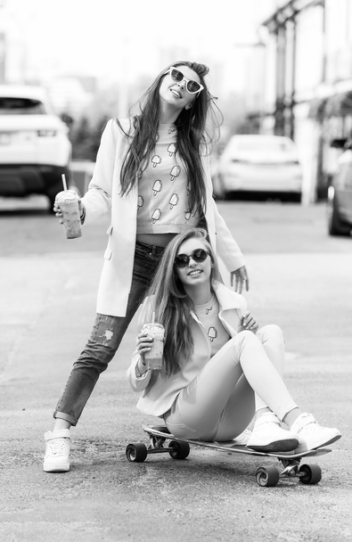 Hipster girlfriends taking a selfie in urban city context - Concept of friendship and fun with new trends and technology - Best friends eternalizing the moment with camera - 写真・画像