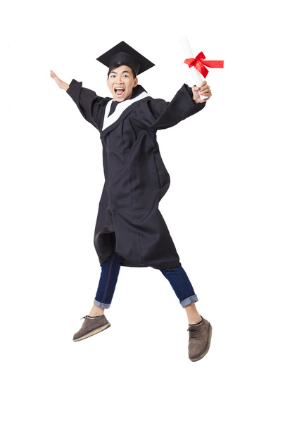 Happy  student in graduate robe jumping isolated on white - Photo, Image