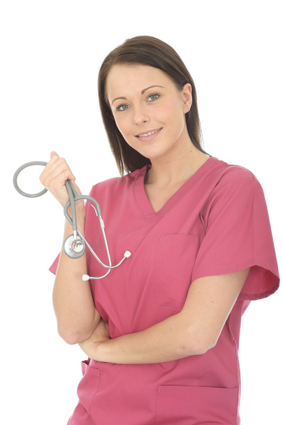 Portrait of a Beautiful Young Female Doctor Wearing Pink Theatre Scrubs Holding A Stethoscope - Foto, Bild