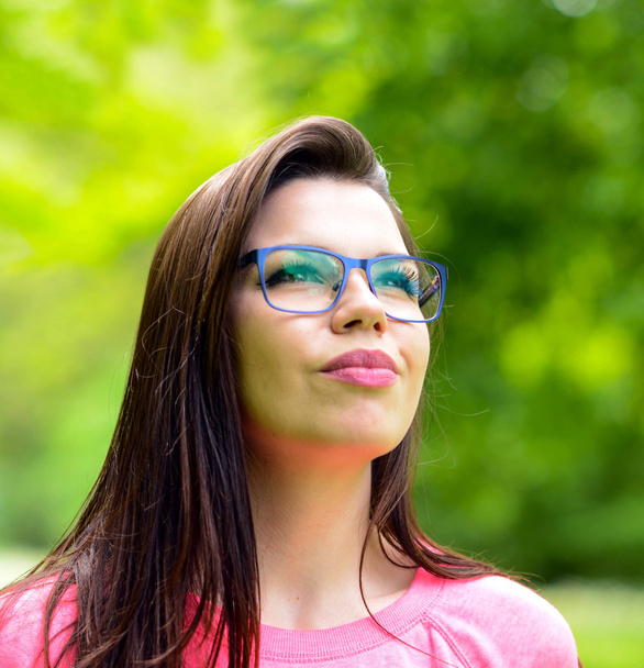 Portrait charming young woman glasses smiling background summer  - Фото, изображение