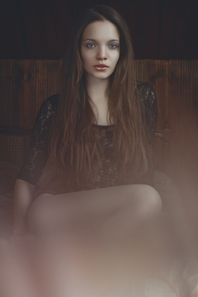 Cute young fashion model in a warm room with wood in bodysuit - Fotó, kép