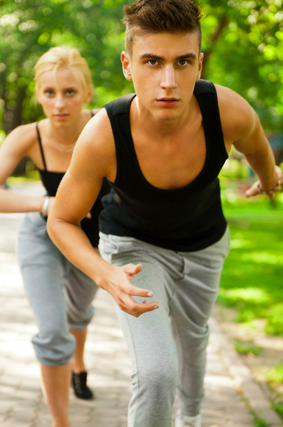 Closeup Portrait of Young Couple Jogging In Park - Foto, Bild