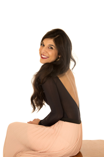 Pretty brunette female model sitting smiling side view - Fotó, kép