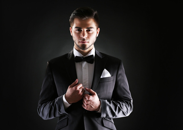 Elegant man in suit on dark background - Фото, зображення