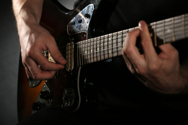Young man playing on electric guitar - Фото, зображення