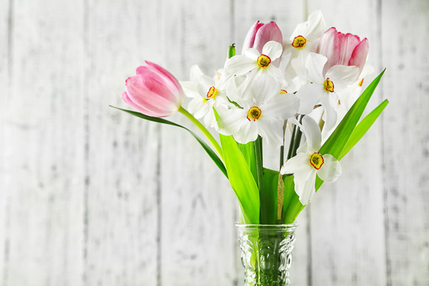 Spring bouquet in vase on color wooden background - Zdjęcie, obraz