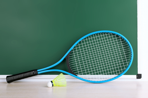 Tennis racket and shuttlecocks on blackboard background - Φωτογραφία, εικόνα