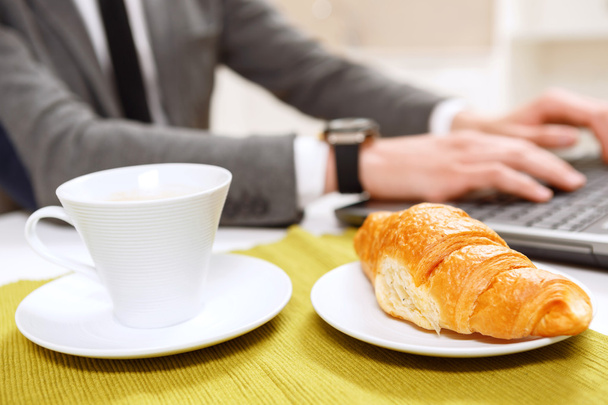 Close up of croissant and cup coffee. - Fotó, kép