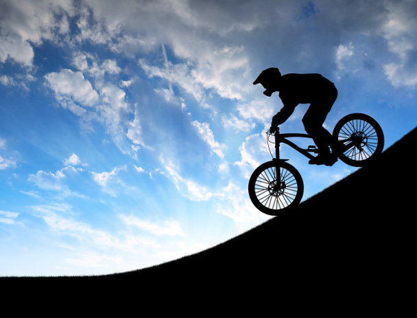 Silhouette of the cyclist on downhill bike - Photo, Image