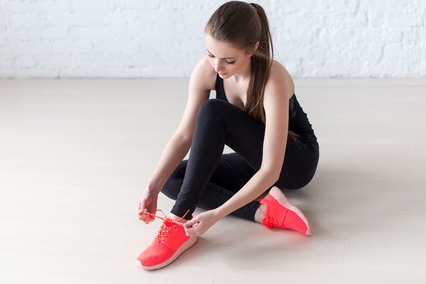 Sportive active girl lacing trainers sports shoes tie shoelaces - Fotografie, Obrázek