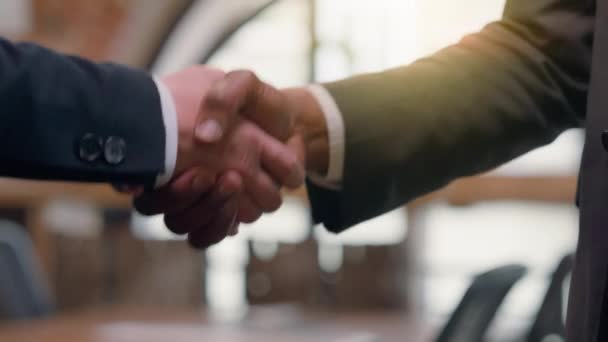 Close up two success businessmen multiracial diversity multiethnic business people partners partnership team work cooperation deal greeting welcome office hire African Asian men handshake hand shake hands - Materiał filmowy, wideo