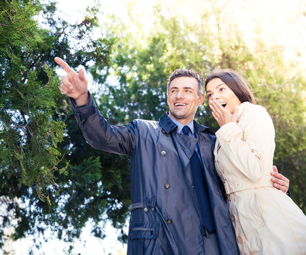 Man pointing on something with happy woman - Фото, зображення