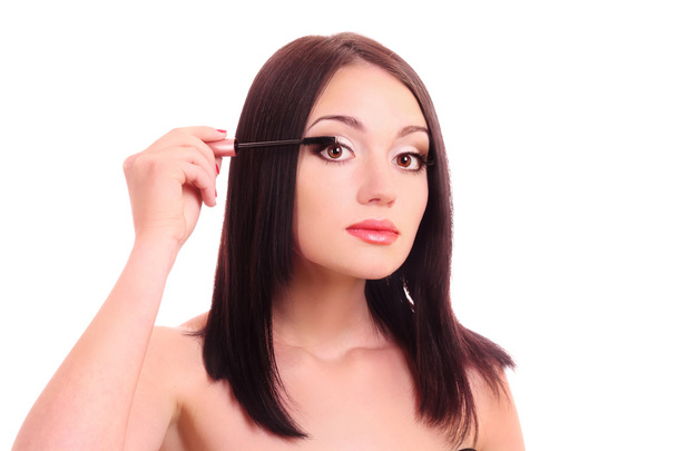 Beautiful young woman with mascara brush - Фото, изображение