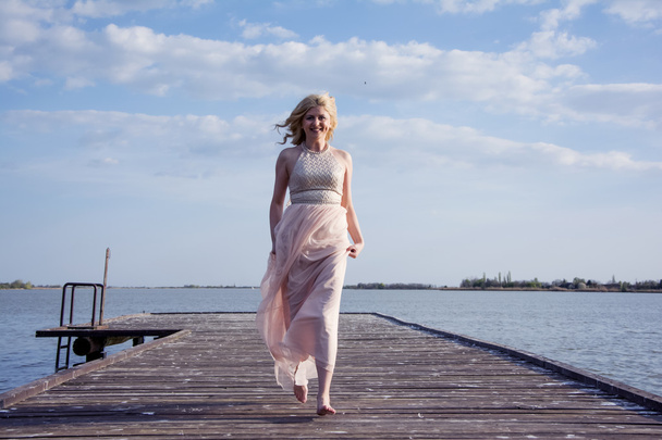 Blond woman in evening gown running - Foto, Imagem
