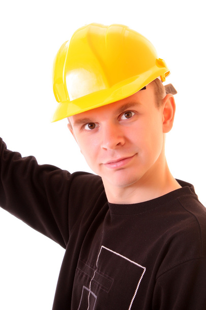 Handsome young men in a yellow building helmet isolated on whi - Foto, afbeelding