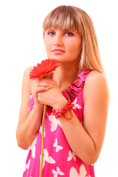 Beautiful young girl in pink dress with red flower - 写真・画像