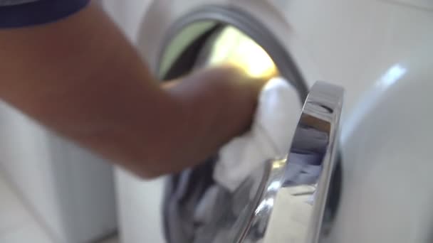 Man Putting Laundry Into Washing Machine - Felvétel, videó