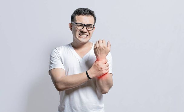 Handsome man with wrist pain isolated, Arthritis and wrist pain concept, People with wrist pain on isolated background, Arthritis man rubbing, Person with wrist pain - Photo, Image