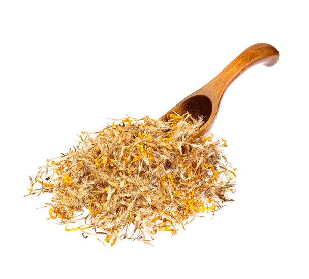 Mountain arnica on the wooden spoon. - Photo, Image