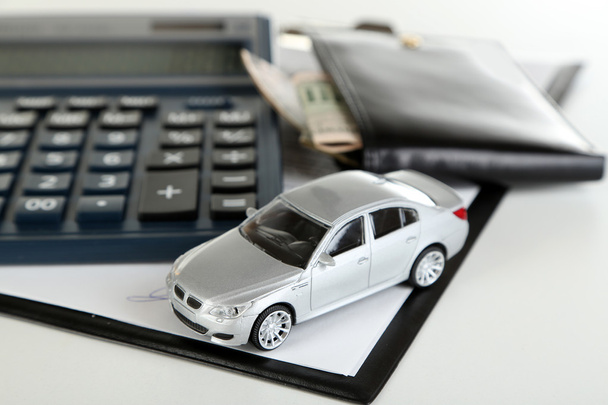 Tablet, calculator and toy car - Фото, изображение