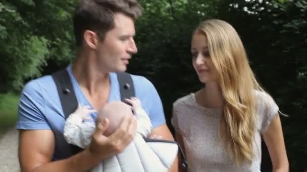 Parents With Baby In Carrier On Walk In Countryside - Filmmaterial, Video