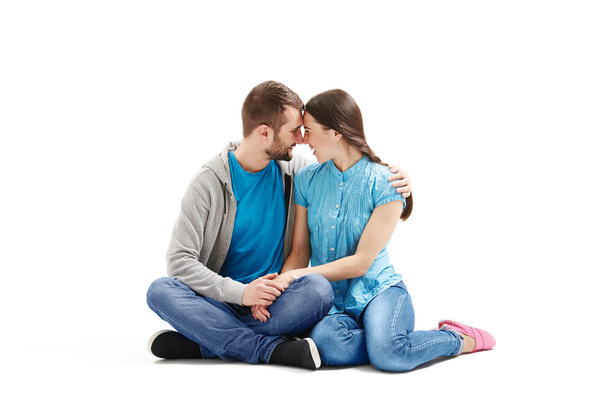 young couple sitting on the floor - Фото, изображение