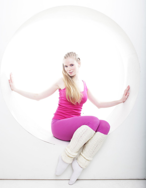 sporty woman posing in pink circle - Foto, Imagem