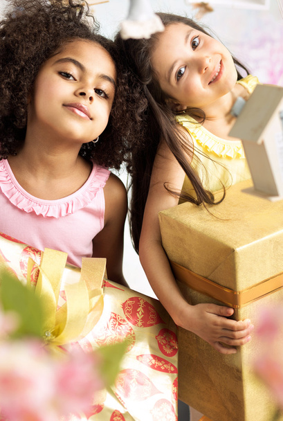 Portrait of two cute girls with the gifts - Fotó, kép