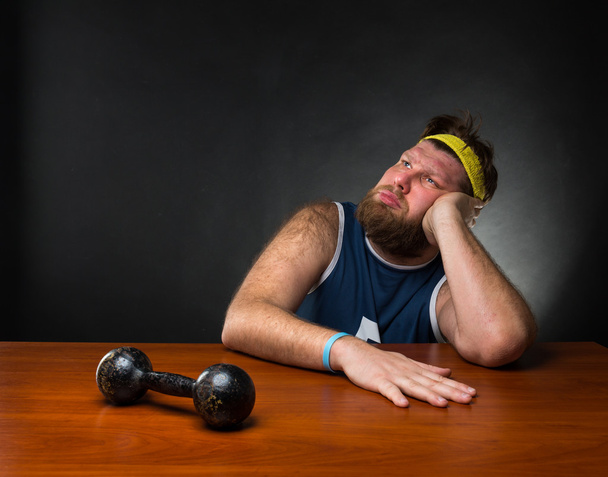 Dreaming man with dumbbell - Photo, Image