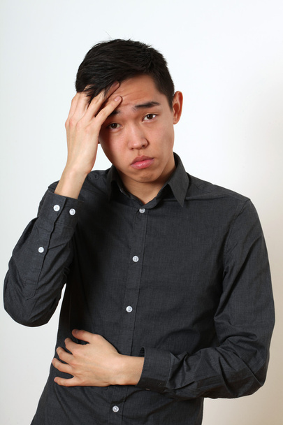 Frustrated Asian man - Фото, зображення