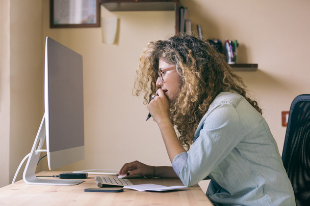 Young woman working at home or in a small office - Photo, image