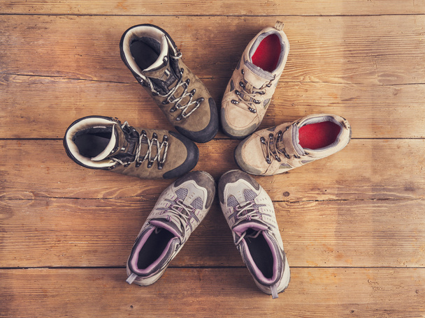 Hiking shoes on a wooden floor - 写真・画像
