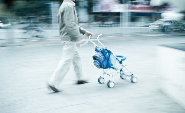 Man with stroller rushing - Foto, afbeelding