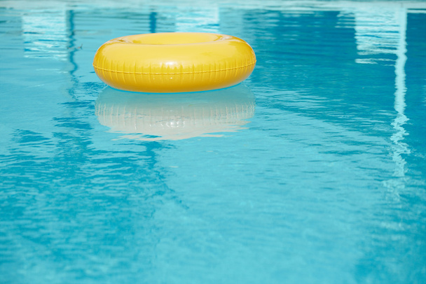 Anillo flotante en la piscina de agua azul
 - Foto, Imagen