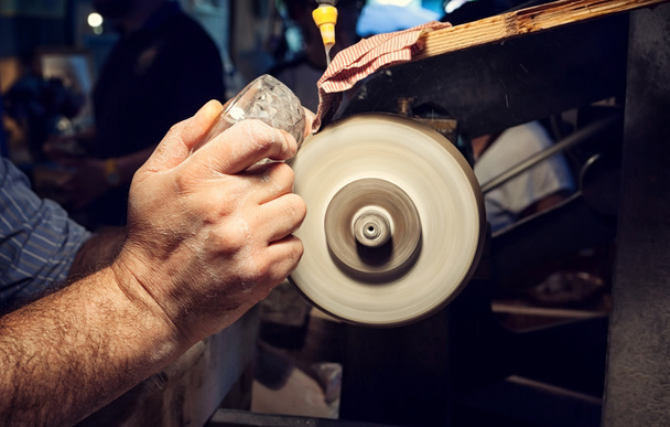 Craftsman during sanding of a crystal ashtrays - Photo, Image