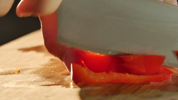 Person cutting red bell pepper - Filmati, video