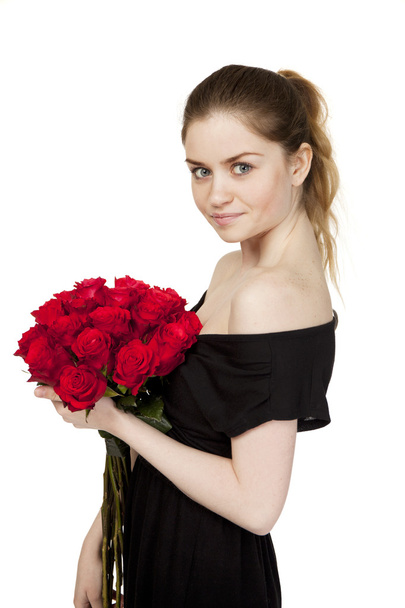 Portrait of a young beautiful girl with a bouquet of red roses - Fotoğraf, Görsel