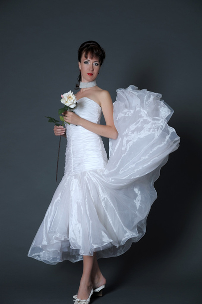 The happy bride with a white rose - Фото, зображення