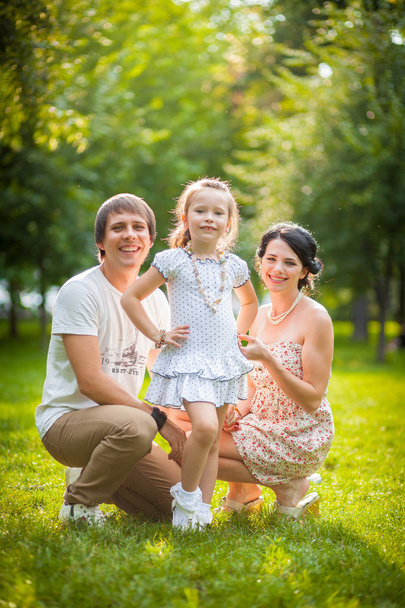 Young family playing with a baby in the park - Foto, Bild