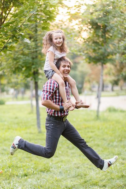 Dad and daughter jumping - Photo, image