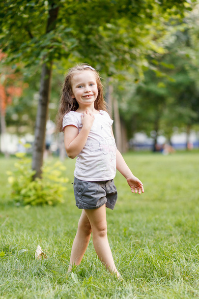 little girl stands on the grass - Photo, Image