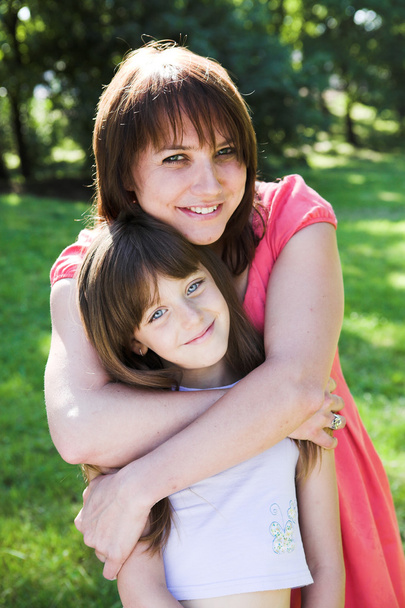 Mother and daughter smiling outdoor. - Фото, изображение