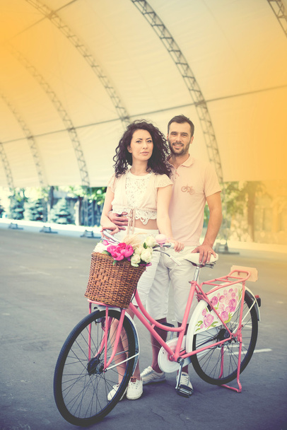 Couple with pink vintage bicycle in the summer park - Φωτογραφία, εικόνα
