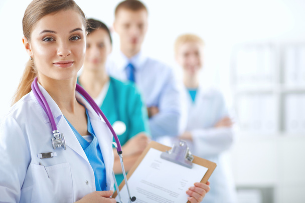 Woman doctor standing with folder at hospital - Fotó, kép