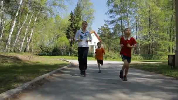 Healthy family running on the road together - Footage, Video