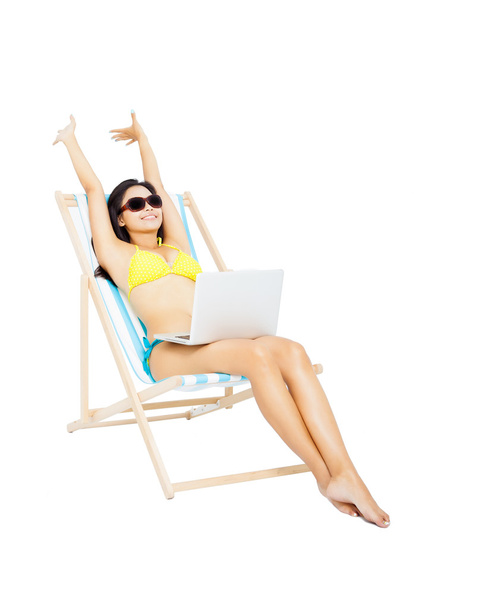 young woman in bikini sitting with laptop - Foto, afbeelding