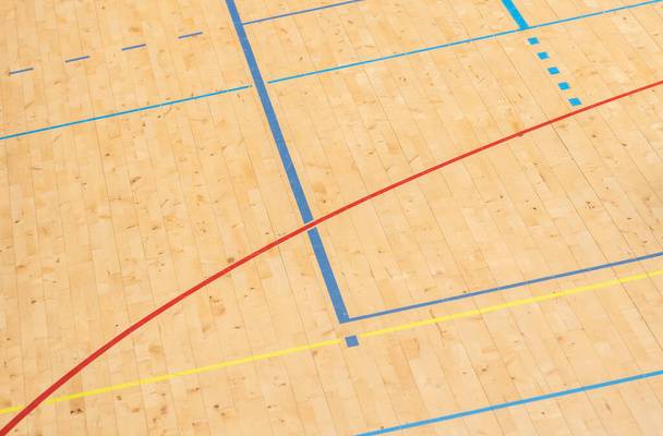 Wooden floor basketball, badminton, futsal, handball, volleyball, football, soccer court. Wooden floor of sports hall with marking lines on wooden floor indoor, gym court - Photo, Image
