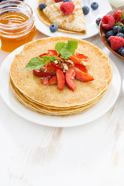 Delicious crepes with strawberries and honey on white - Zdjęcie, obraz